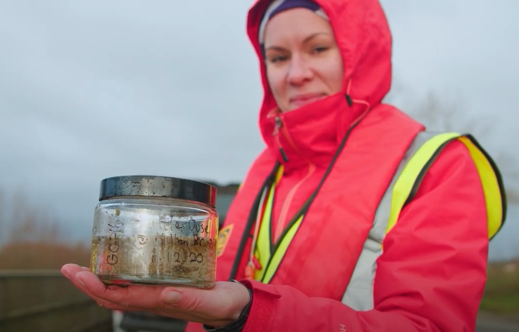 Ecologist holding plastic from water sample
