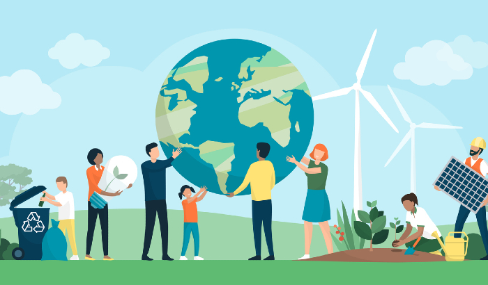 group of people holding the earth next to a wind turbine