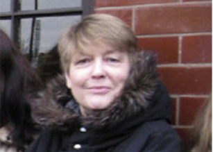 a smiling woman in black winter coat