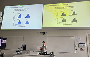 Female lecturer presenting to audience in front of screen