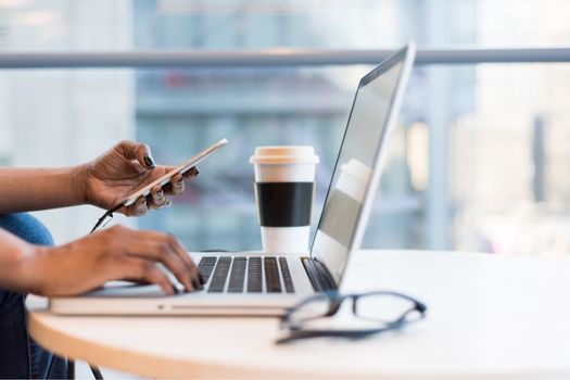 A person sitting at a table in front of a laptop computer