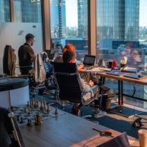 Employees at Desk Overlooking City