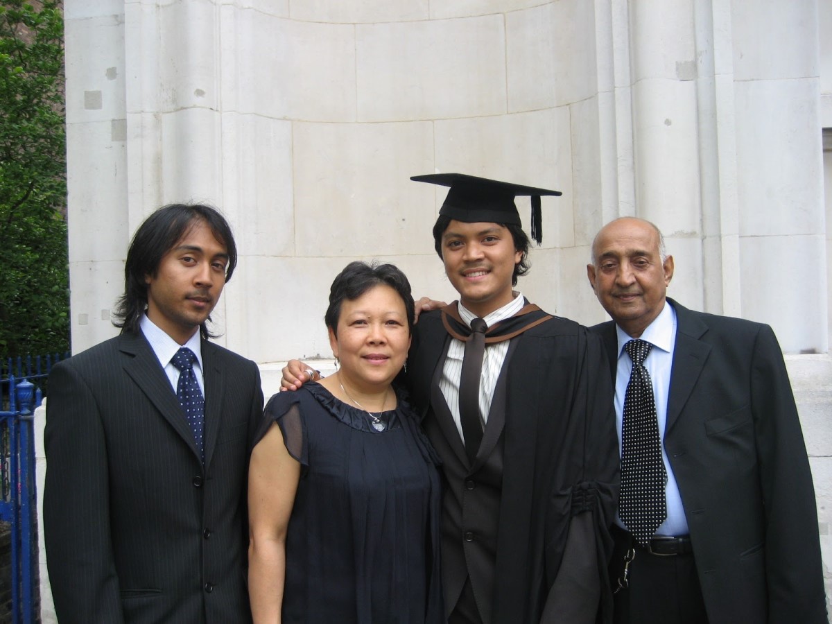 Photo of alumnus, Kamran Khan, with his mother, father, and brother at his graduation ceremony