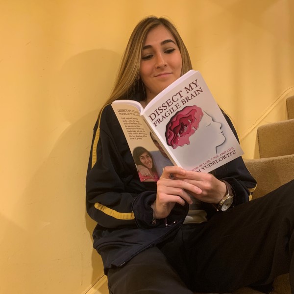 Photo of alumna, Kim Yudelowitz, reading her book