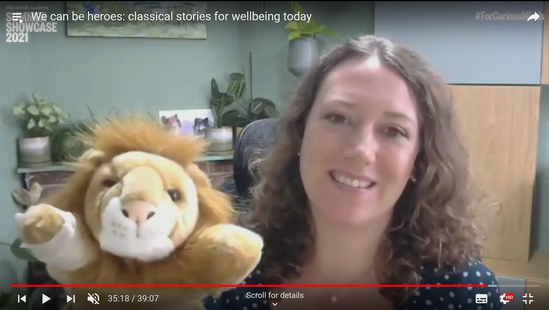 screenshot from British Academy Showcase 2021 showing Rachel Bryant Davies presenting with a lion hand puppet