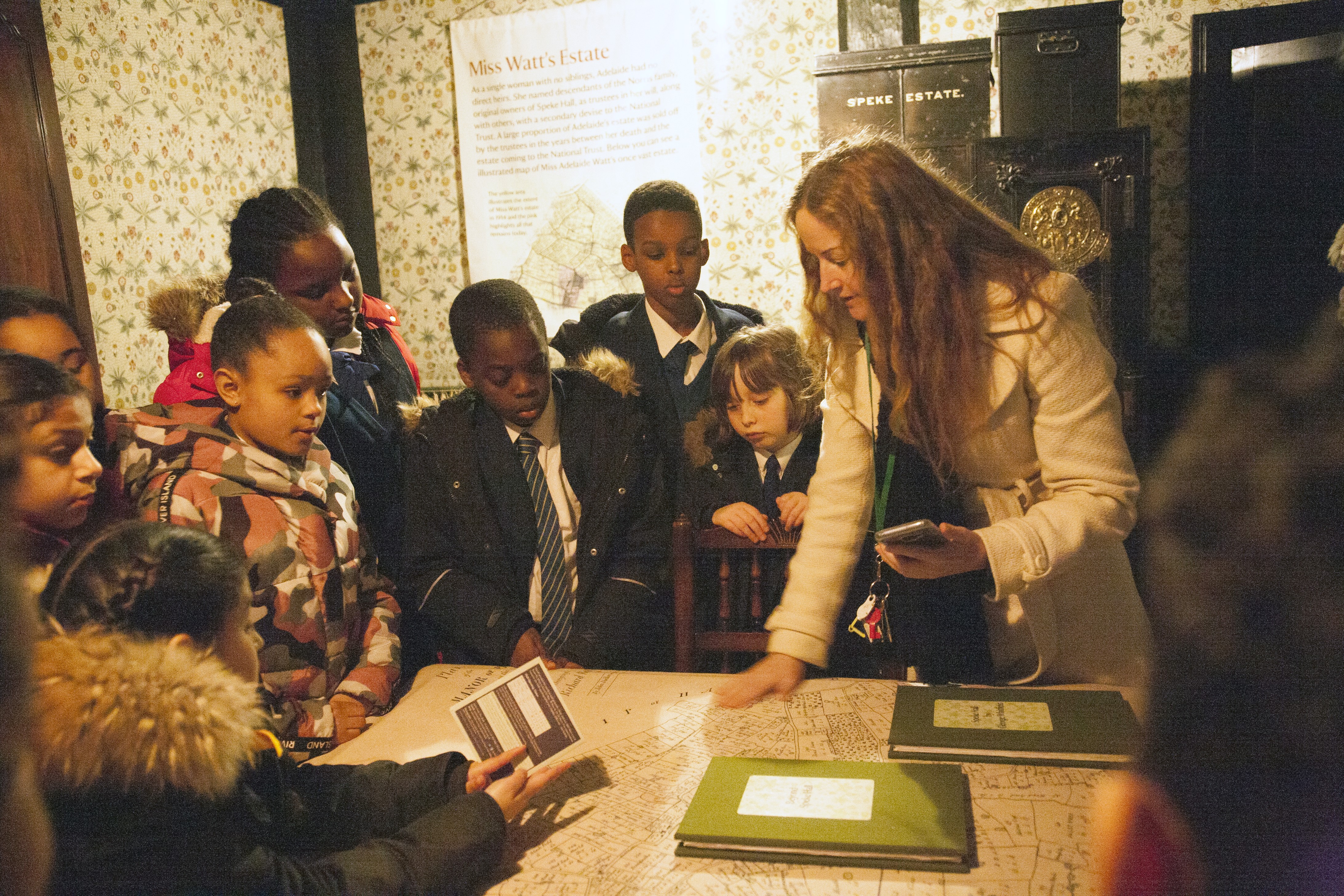 Prof Corinne Fowlere with pupils gathered around a table in a project activity