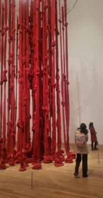 partial photograph of Cecilia Vicuña’s 'Quipu womb' sculpture at Tate Modern