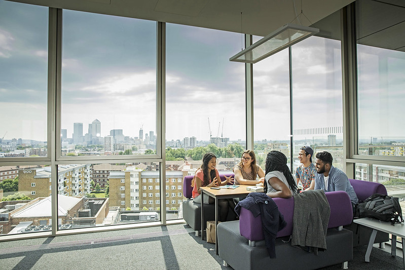 A group of students sitting in the Graduate Centre, with a view across the City of London