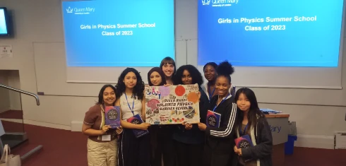 A team of students holding their winning poster at the Girls into Physics summer school 2023.