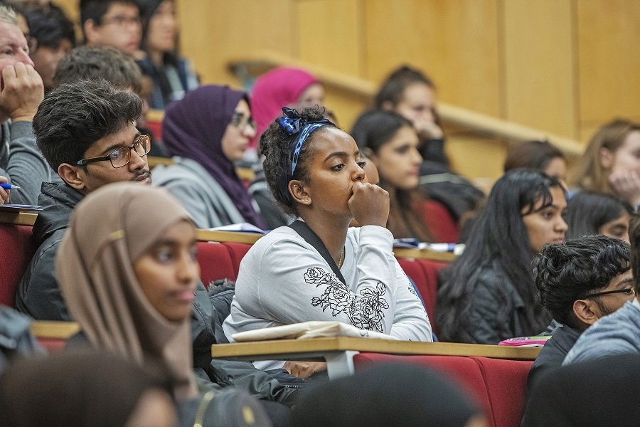 Queen Mary Summer School students in a lecture theatre listening to a teacher