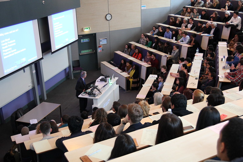 Lecturer presenting to students in a auditorium