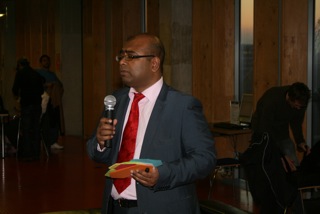 Motin Uz-Zuman former Patient engagement Lead Barts Health Trust at 2010 Let's talk hearts seminar. The paper shapes he holds are to invite feedback on future Let's talk hearts seminars. Paper heart shapes with thoughts on heart health became a feature of Let's talk hearts seminars.