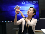 Dr Jianmin Chen holding a model heart as part of her presentation, 'Exploring the connection between rheumatoid arthritis and heart health'