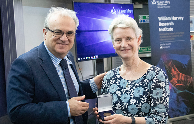 Prof Philipa Saunders (R) receiving the Iain MacIntyre Award for Excellence in Endocrinology from WHRI Director Prof Panos Deloukas (L).