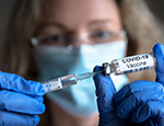 Woman holds Covid-19 vaccine in hands. Credit: scaliger/iStock.com