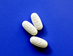 Metformine prescription pills with identification numbers on blue background