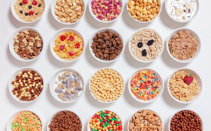 Bowls of sugary breakfast cereals on a white background