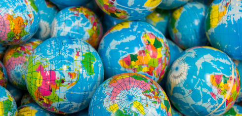 A photo of multiple world globes, symbolising our global impact