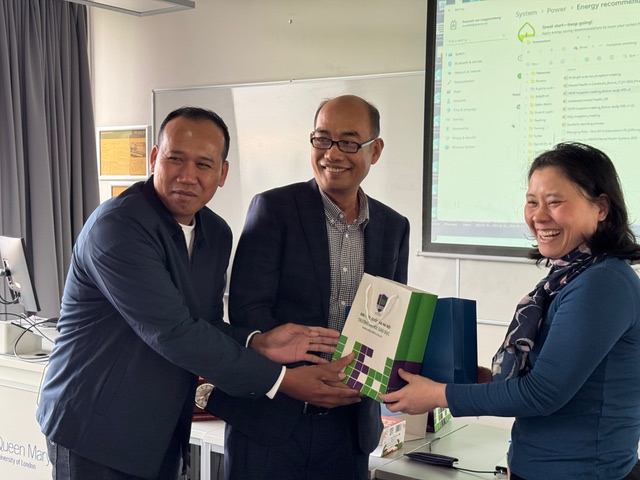 Three external guests to QMUL exchange gifts to each other at the inception meeting of a new project.