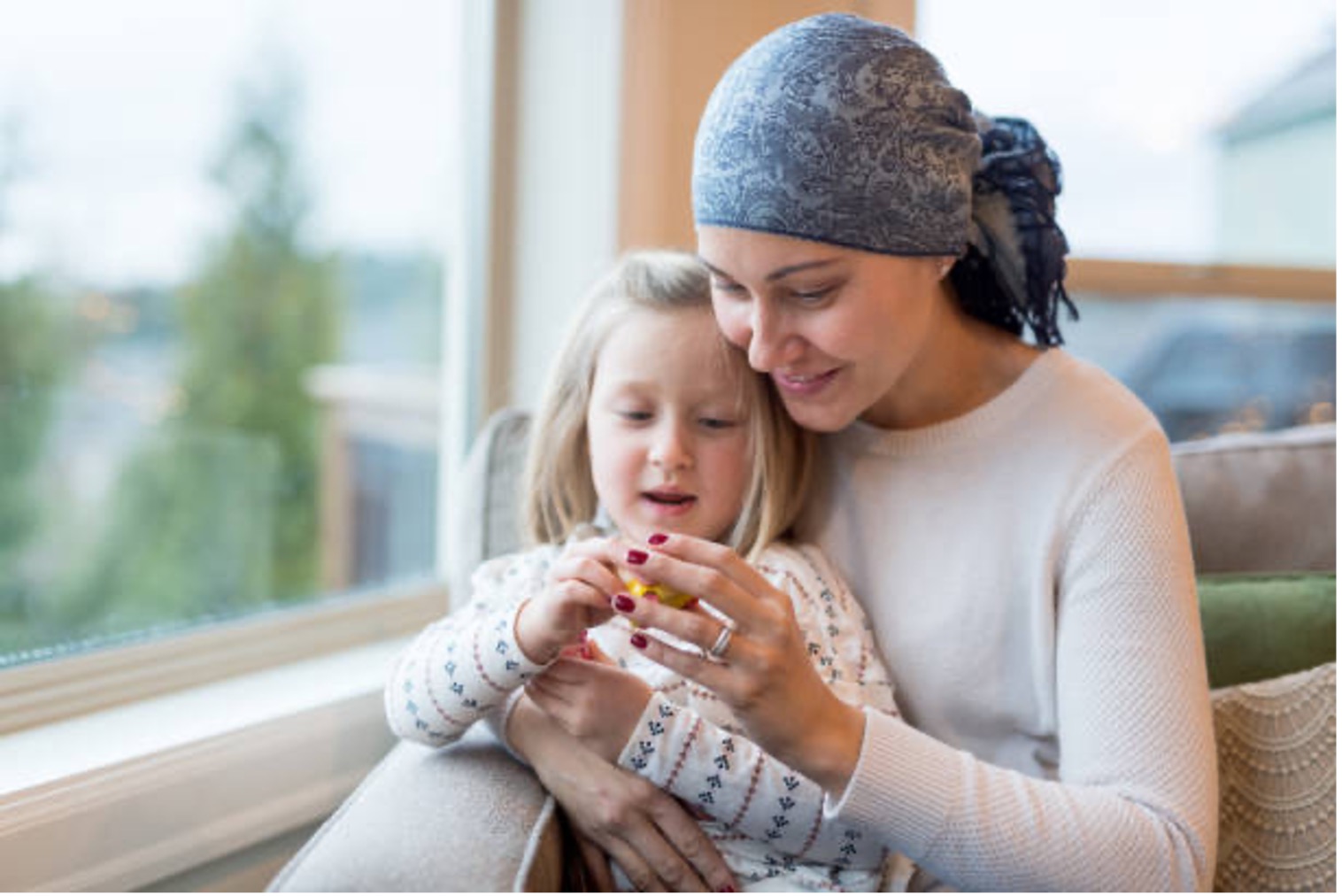 Mother with head scarf sitting with daughter