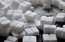 Sugar cubes spread on black background