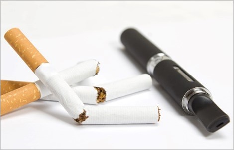Three broken cigarettes sit alongside an e-cigarette