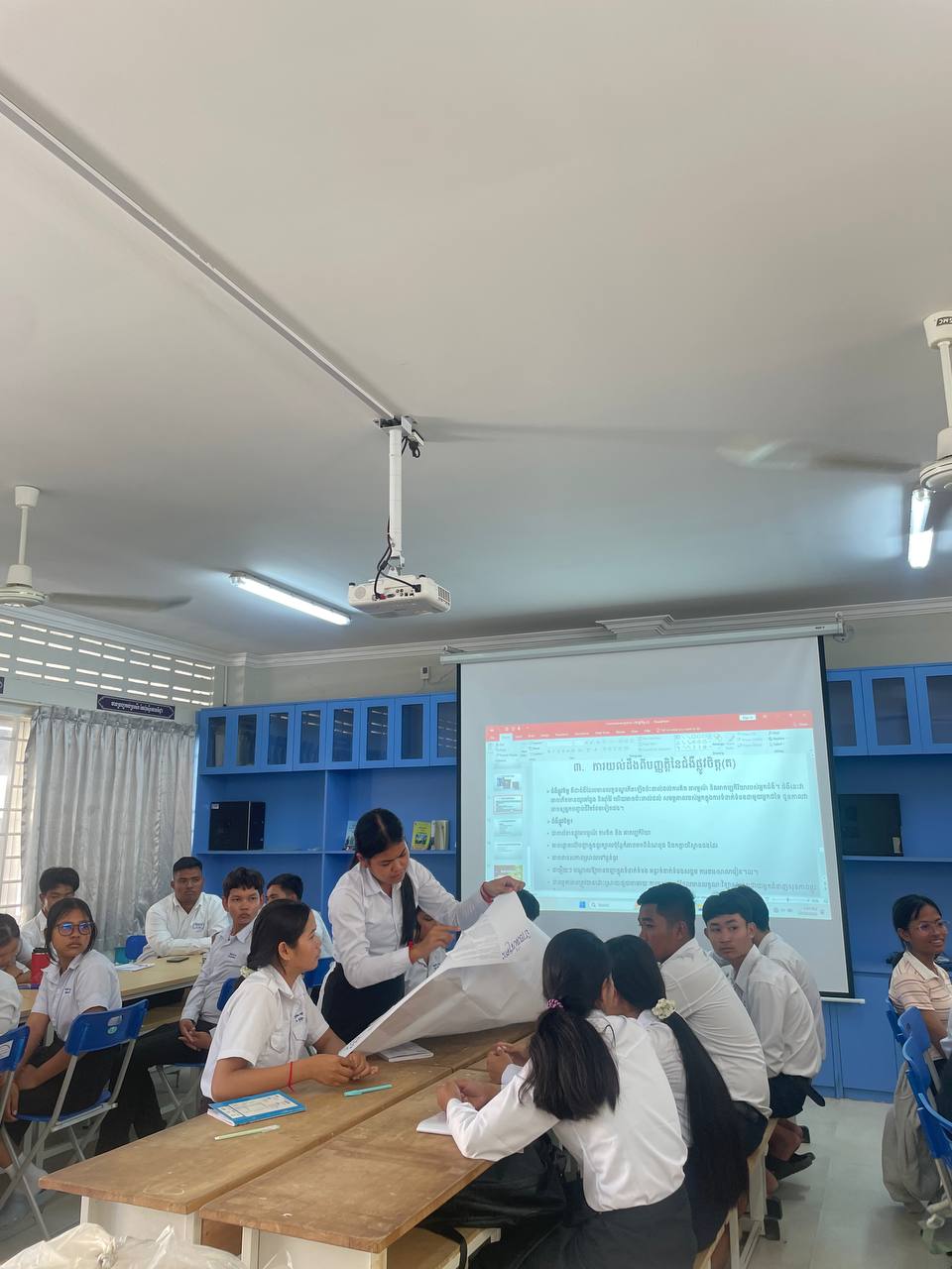 students working on training in front of a screen